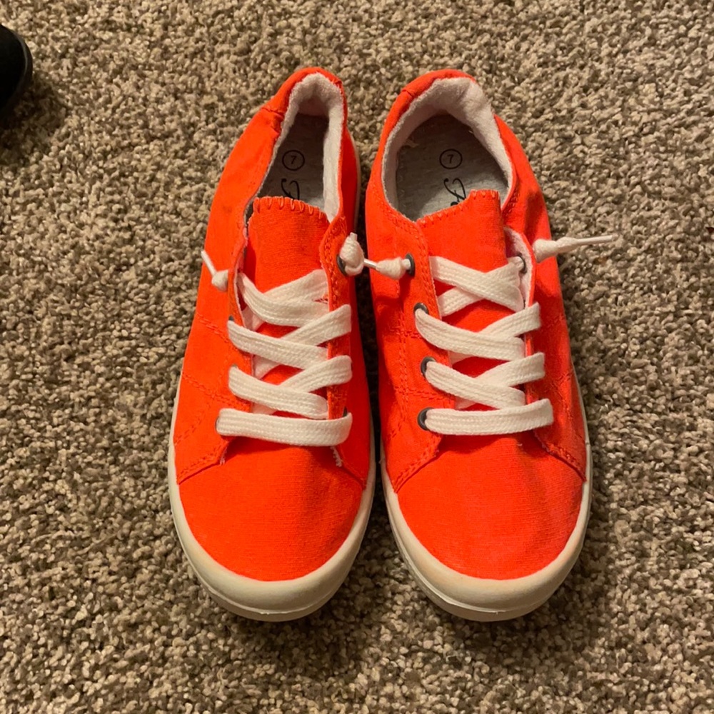 Bright orange slip on sneakers